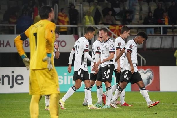 Jamal Musiala of Germany celebrates after scoring his team's fourth goal with teammates during the 2022 FIFA World Cup Qualifier match between North...