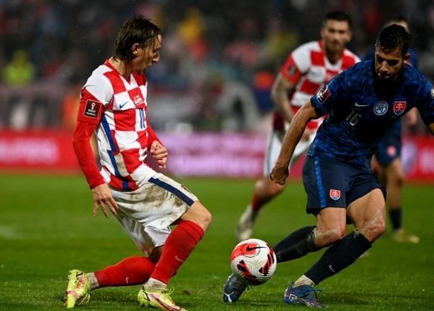 Croatia's midfielder Luka Modric fights for the ball with Slovakia's midfielder David Hancko during the FIFA World Cup Qatar 2022 qualification Group...