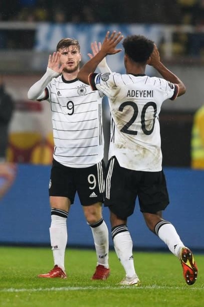 Germany's forward Timo Werner celebrates after scoring his team's third goal with Germany's midfielder Karim Adeyemi during the FIFA World Cup Qatar...