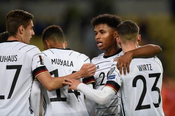 Germany's forward Jamal Musiala celebrates after scoring his team's fourth goal with teammates Germany's midfielder Karim Adeyemi , Germany's...