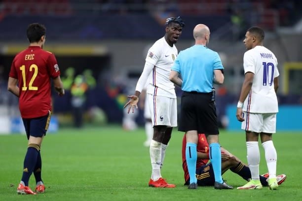 Paul Pogba of France and Kylian Mbappe of France and Anthony Taylor speak with during the UEFA Nations League Final match between the Spain and...