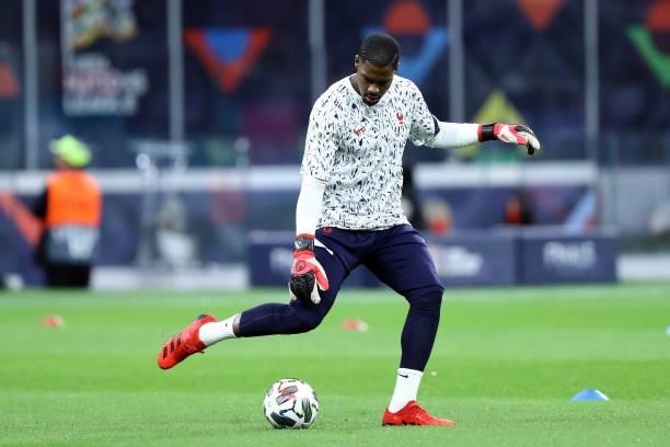 Mike Maignan of France warm up prior to the UEFA Nations League Final match between the Spain and France at San Siro Stadium on October 10, 2021 in...