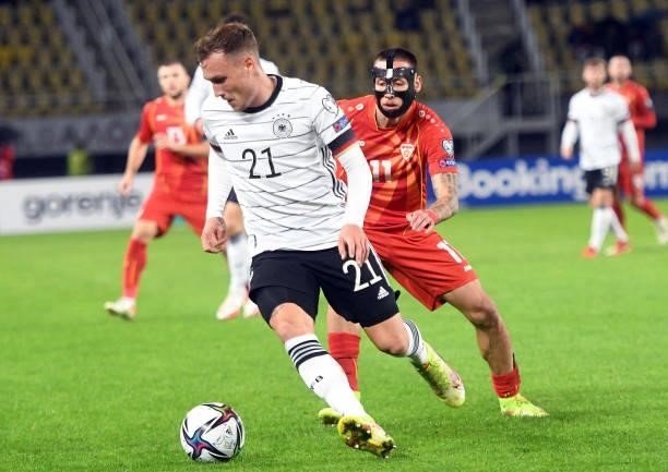 Macedonia's Darko Churlinov and Germany's David Raum fight for the ball during the FIFA World Cup Qatar 2022 qualification Group J football match...