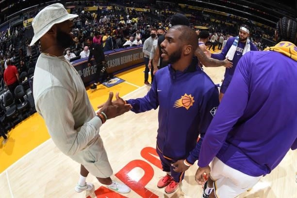 LeBron James of the Los Angeles Lakers and Chris Paul of the Phoenix Suns embrace after a preseason game on October 10, 2021 at STAPLES Center in Los...