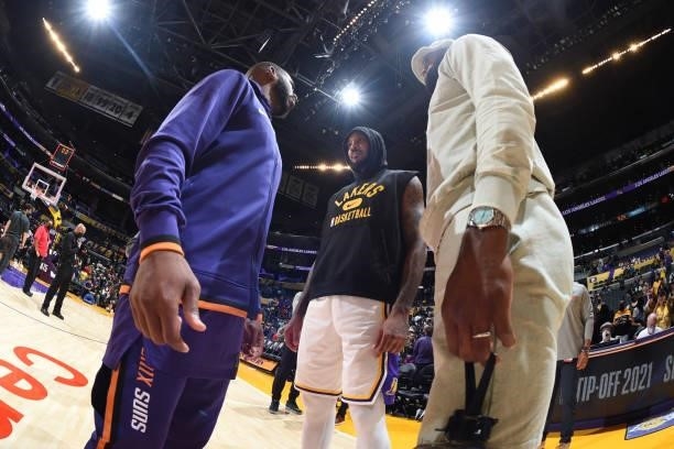 LeBron James, Carmelo Anthony of the Los Angeles Lakers and Chris Paul of the Phoenix Suns embrace after a preseason game on October 10, 2021 at...