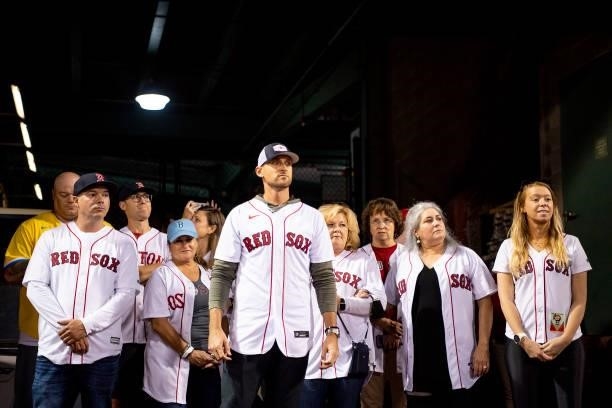 Former third baseman Will Middlebrooks of the Boston Red Sox looks on with survivors of the Boston Marathon bombing before throwing out a ceremonial...