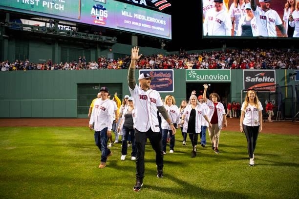 Former third baseman Will Middlebrooks of the Boston Red Sox is introduced with survivors of the Boston Marathon bombing before throwing out a...