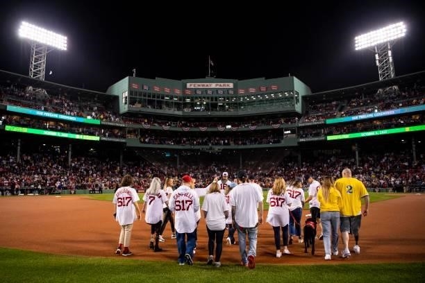 Former third baseman Will Middlebrooks of the Boston Red Sox is introduced with survivors of the Boston Marathon bombing before throwing out a...
