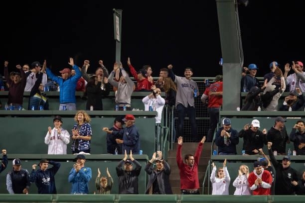 Fans cheer after Rafael Devers of the Boston Red Sox hits a three run home run during the third inning of game four of the 2021 American League...