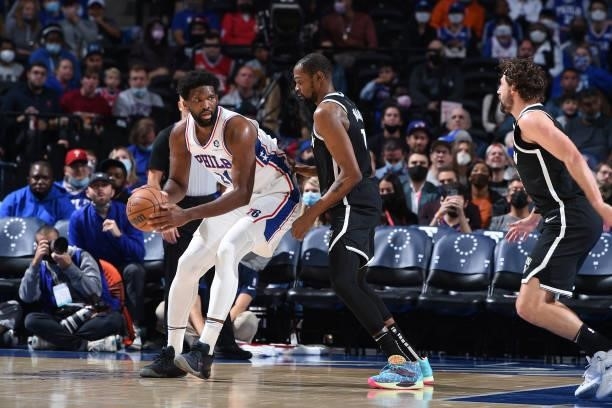 Joel Embiid of the Philadelphia 76ers handles the ball against Kevin Durant of the Brooklyn Nets during a preseason game on October 11, 2021 at Wells...