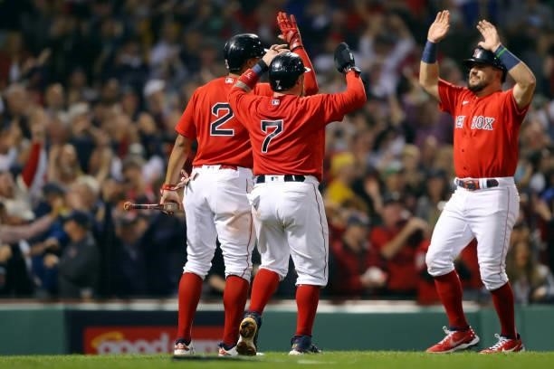 Kyle Schwarber of the Boston Red Sox celebrates with Xander Bogaerts and Christian Vázquez after scoring a run in the bottom of the third inning...