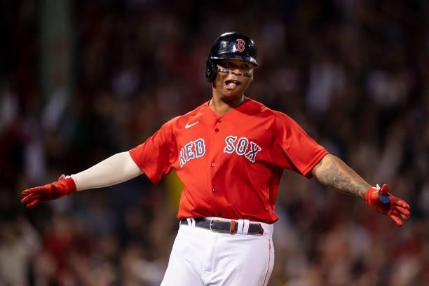Rafael Devers of the Boston Red Sox reacts after hitting a three run home run during the third inning of game four of the 2021 American League...