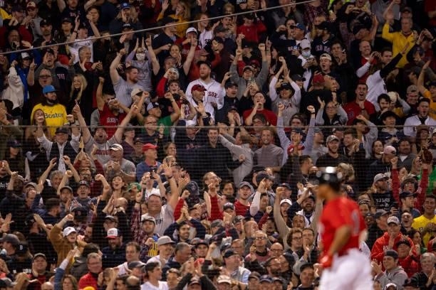 Fans react as Rafael Devers of the Boston Red Sox rounds the bases after hitting a three run home run during the third inning of game four of the...