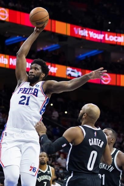 Joel Embiid of the Philadelphia 76ers dunks the ball past Jevon Carter of the Brooklyn Nets in the first half at the Wells Fargo Center on October...