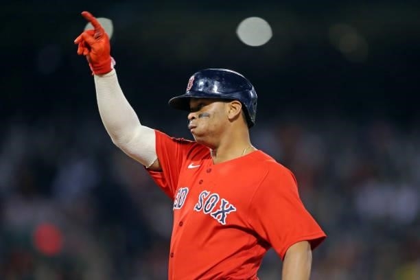 Rafael Devers of the Boston Red Sox reacts after hitting a single in the bottom of the eighth inning during Game 4 of the ALDS between the Tampa Bay...