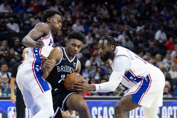 Cam Thomas of the Brooklyn Nets drives to the basket against Paul Reed and Andre Drummond of the Philadelphia 76ers in the second half at the Wells...