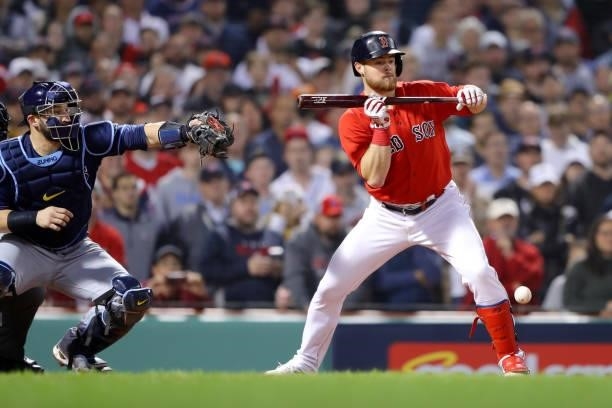 Christian Arroyo of the Boston Red Sox hits a sacrifice bunt in the bottom of the ninth inning during Game 4 of the ALDS between the Tampa Bay Rays...