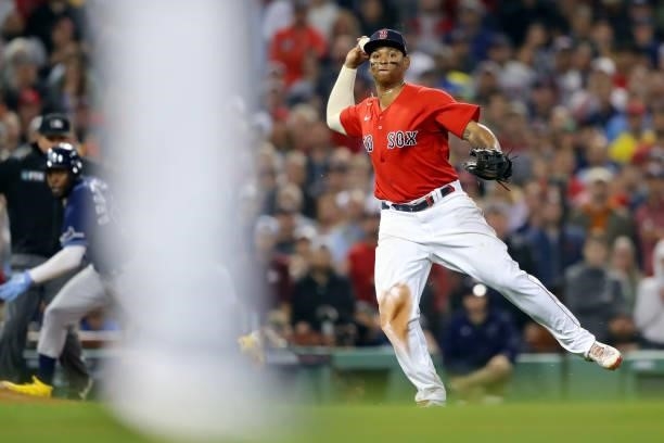 Rafael Devers of the Boston Red Sox throws to first base in the top of the eighth inning during Game 4 of the ALDS between the Tampa Bay Rays and the...