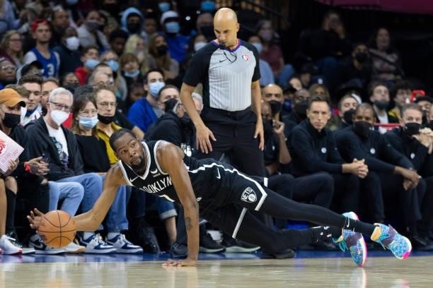 Kevin Durant of the Brooklyn Nets dives for the ball against the Philadelphia 76ers in the first half at the Wells Fargo Center on October 11, 2021...
