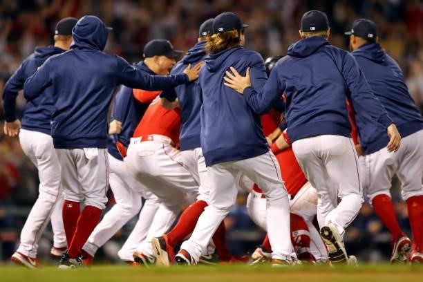 Members of the Boston Red Sox celebrate after defeating the Tampa Bay Rays 6-5 in Game 4 of the ALDS at Fenway Park on Monday, October 11, 2021 in...