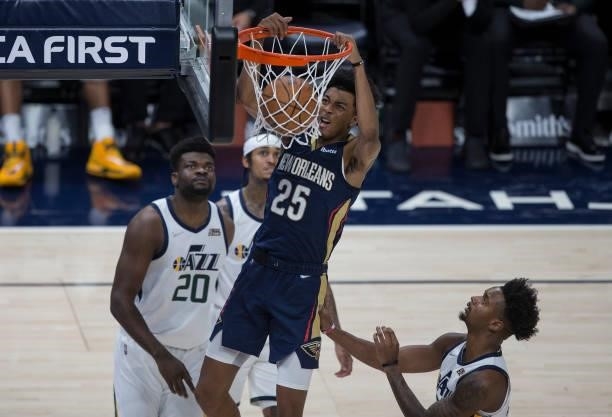 Trey Marshall III of the New Orleans Pelicans dunks the ball over Elijah Hughes and Udoka Azubuike of the Utah Jazz during the second half of their...