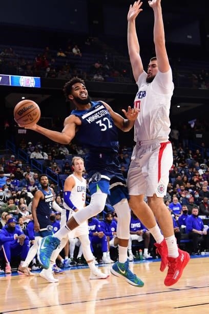 Karl-Anthony Towns of the Minnesota Timberwolves drives to the basket and looks to pass the ball during a preseason game against the LA Clippers on...