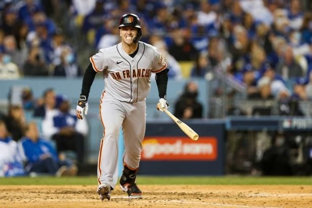 Buster Posey of the San Francisco Giants reacts after flying out in the sixth inning during Game 3 of the NLDS between the San Francisco Giants and...