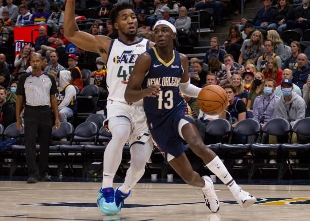 Kira Lewis Jr of the New Orleans Pelicans drives around Donovan Mitchell of the Utah Jazz during the second half of their game on October 11, 2021 at...