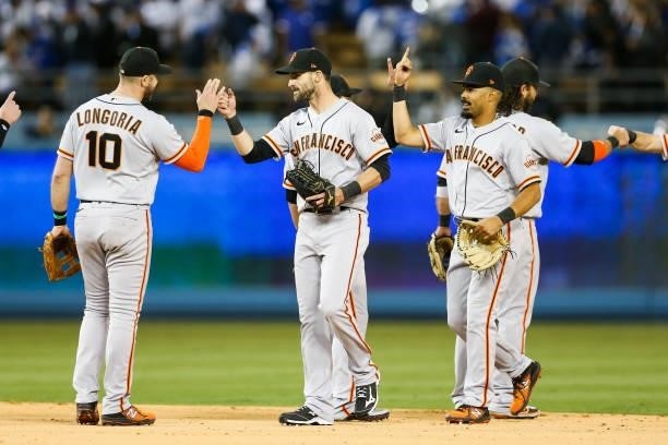 Evan Longoria of the San Francisco Giants and Steven Duggar celebrate after the final out beating the Los Angeles Dodgers 1-0 during Game 3 of the...