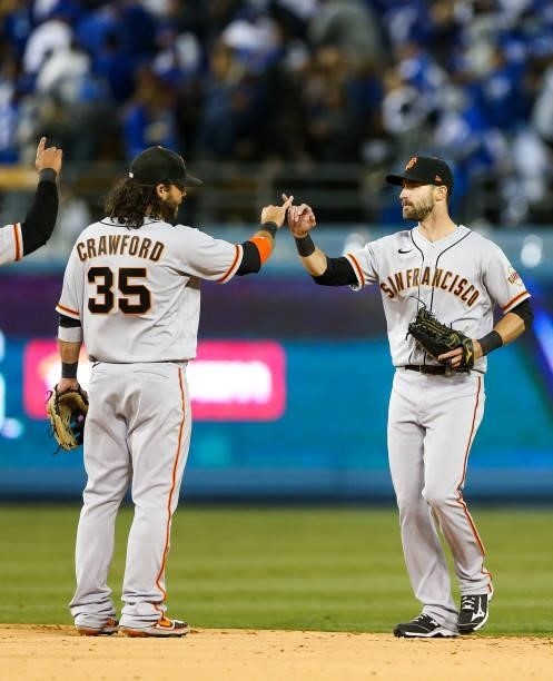 Brandon Crawford of the San Francisco Giants and Steven Duggar of the San Francisco Giants celebrate after the final out beating the Los Angeles...