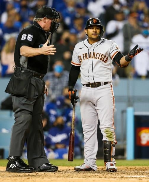 Donovan Solano of the San Francisco Giants argues with umpire Ted Barrett after being called out on strikes during Game 3 of the NLDS between the San...