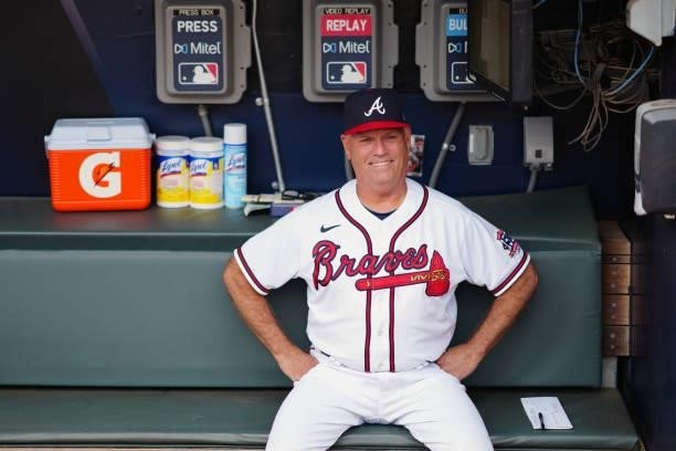 Manager Brian Snitker of the Atlanta Braves smiles in the dugout prior to Game 4 of the NLDS between the Milwaukee Brewers and the Atlanta Braves at...