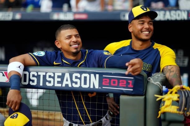 Eduardo Escobar and Freddy Peralta of the Milwaukee Brewers look on from the dugout prior to Game 4 of the NLDS between the Milwaukee Brewers and the...