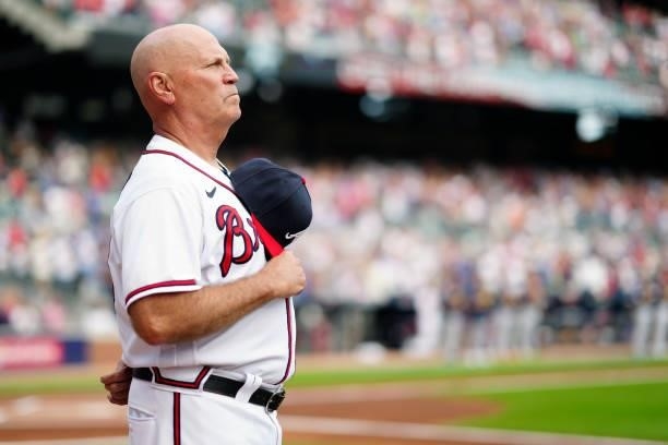 Manager Brian Snitker of the Atlanta Braves looks on during the national anthem prior to Game 4 of the NLDS between the Milwaukee Brewers and the...