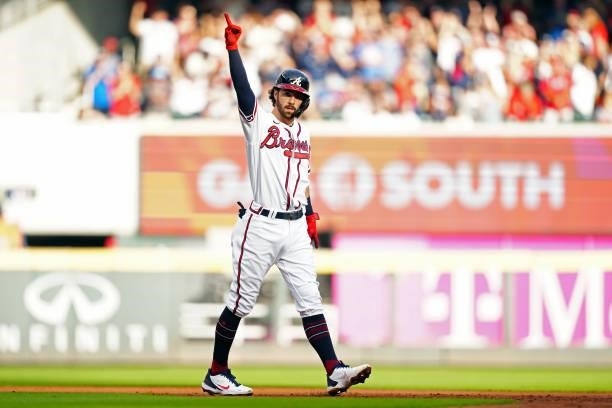Dansby Swanson of the Atlanta Braves celebrates after hitting a double in the bottom of the first inning during Game 4 of the NLDS between the...