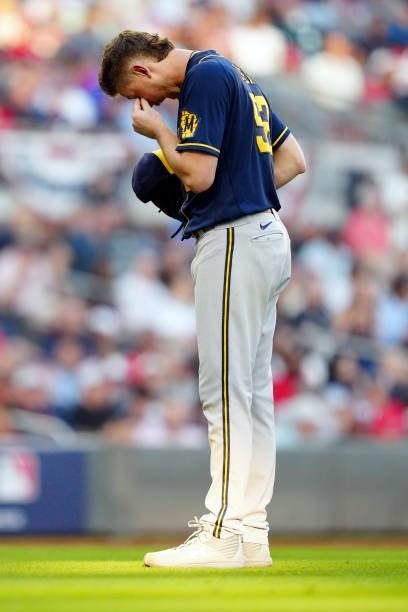 Eric Lauer of the Milwaukee Brewers steps off the mound to try and remove something from his eye during Game 4 of the NLDS between the Milwaukee...