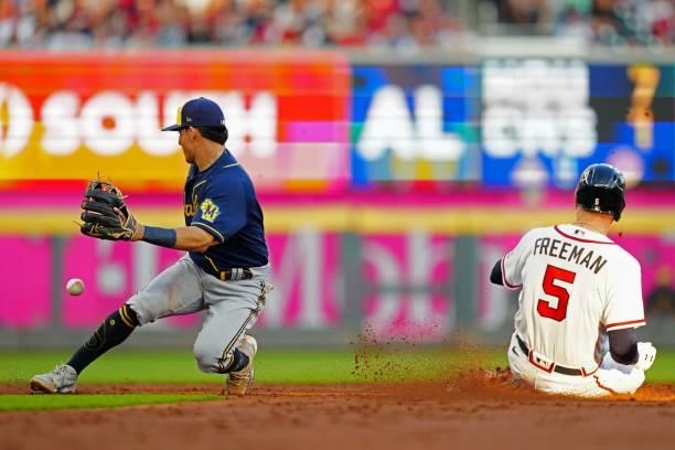 Freddie Freeman of the Atlanta Braves slides in safely at second base after hitting a double in the bottom of the third inning during Game 4 of the...