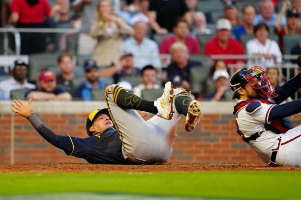 Avisaíl García of the Milwaukee Brewers slides safely into home in the top of the fourth inning during Game 4 of the NLDS between the Milwaukee...