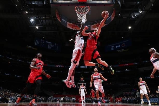 Svi Mykhailiuk of the Toronto Raptors drives to the basket during a preseason game against the Washington Wizards on October 12, 2021 at Capital One...