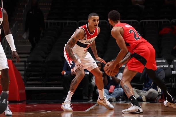 Kyle Kuzma of the Washington Wizards plays defense on Khem Birch of the Toronto Raptors during a preseason game on October 12, 2021 at Capital One...