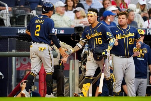 Luis Urías of the Milwaukee Brewers celebrates with teammate Kolten Wong after scoring a run in the top of the fourth inning during Game 4 of the...