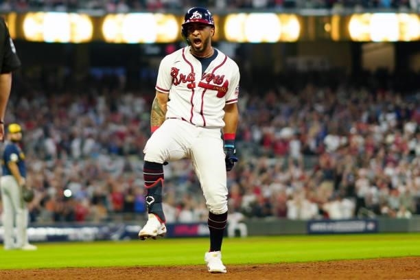 Eddie Rosario of the Atlanta Braves reacts after hitting a two-run single in the bottom of the fourth inning during Game 4 of the NLDS between the...