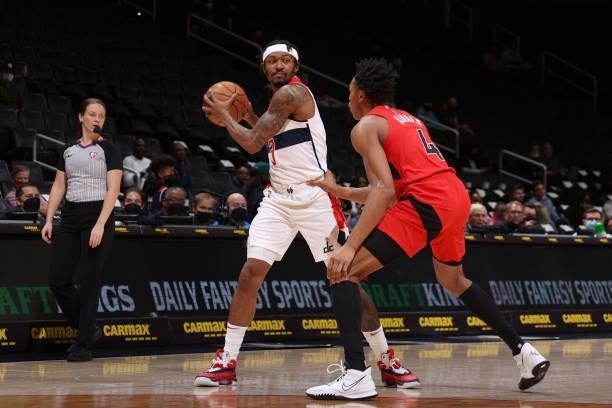 Scottie Barnes of the Toronto Raptors plays defense on Bradley Beal of the Washington Wizards during a preseason game on October 12, 2021 at Capital...