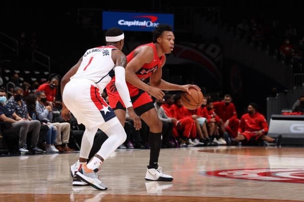 Kentavious Caldwell-Pope of the Washington Wizards plays defense on Scottie Barnes of the Toronto Raptors during a preseason game on October 12, 2021...