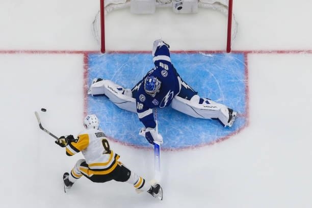 Goalie Andrei Vasilevskiy of the Tampa Bay Lightning makes a save against Evan Rodrigues of the Pittsburgh Penguins during the first period at Amalie...