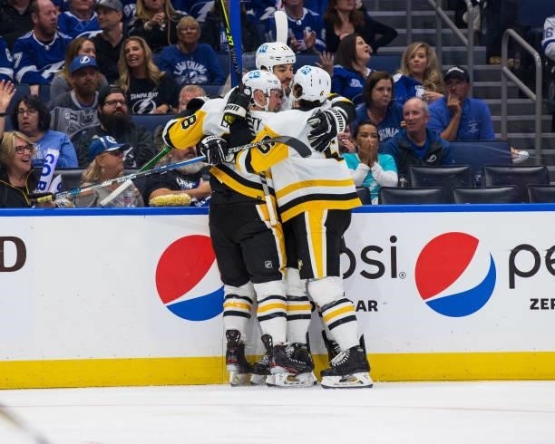 Brian Boyle of the Pittsburgh Penguins celebrates a goal with teammates Sam Lafferty and John Marino against the Tampa Bay Lightning during the...