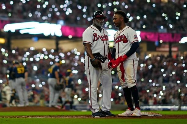 Ozzie Albies of the Atlanta Braves stands on first base after hitting a single in the bottom of the sixth inning during Game 4 of the NLDS between...