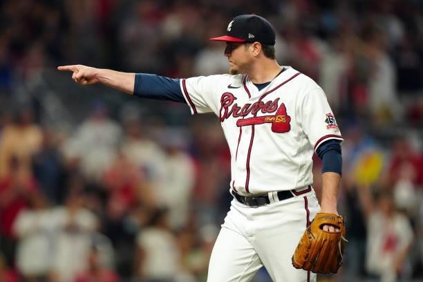 Luke Jackson of the Atlanta Braves reacts after throwing a pitch in the top of the seventh inning during Game 4 of the NLDS between the Milwaukee...