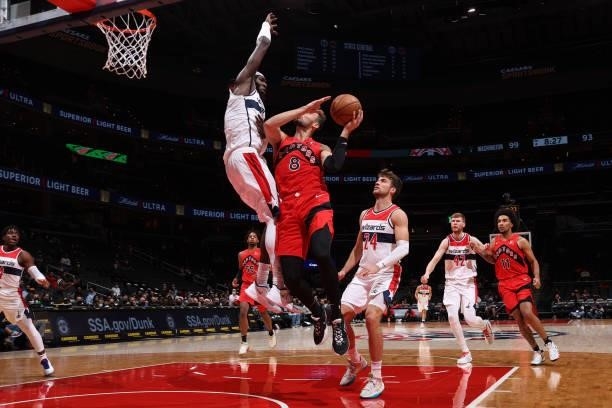Montrezl Harrell of the Washington Wizards plays defense on Sam Dekker of the Toronto Raptors during a preseason game on October 12, 2021 at Capital...