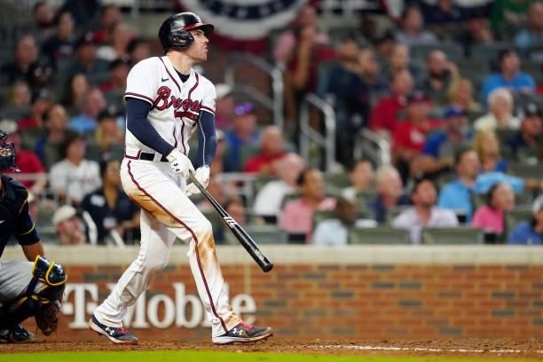 Freddie Freeman of the Atlanta Braves hits a solo home run in the bottom the eighth inning during Game 4 of the NLDS between the Milwaukee Brewers...